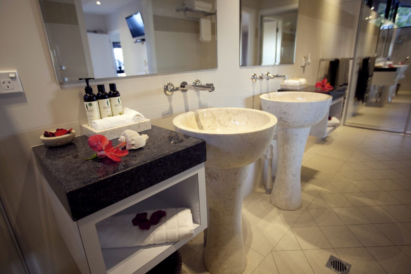 Ensuite bathroom with twin Italian marble pedestal vanities