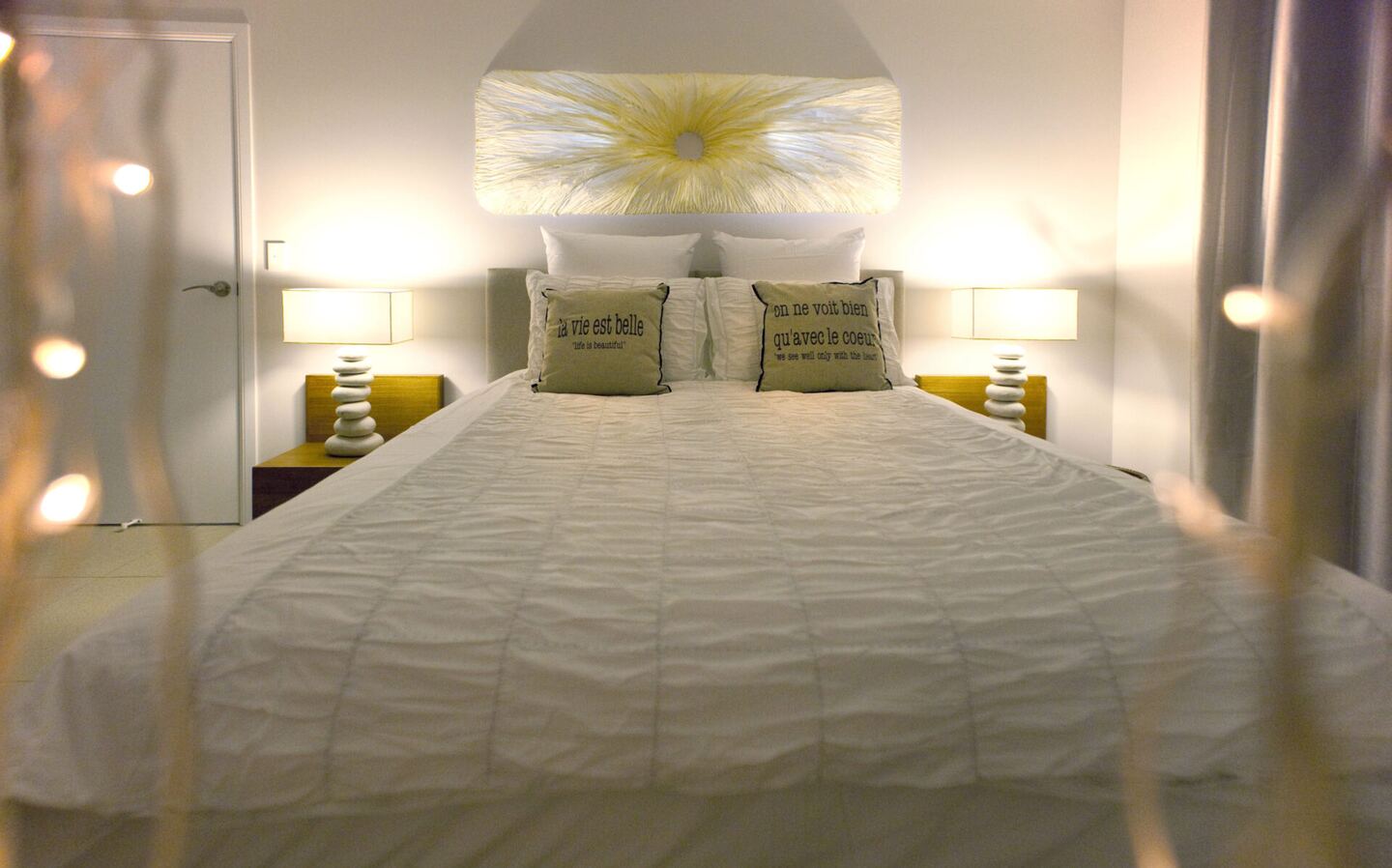 Queen bedroom with bedside lamps and glimpses of the surrounding islands